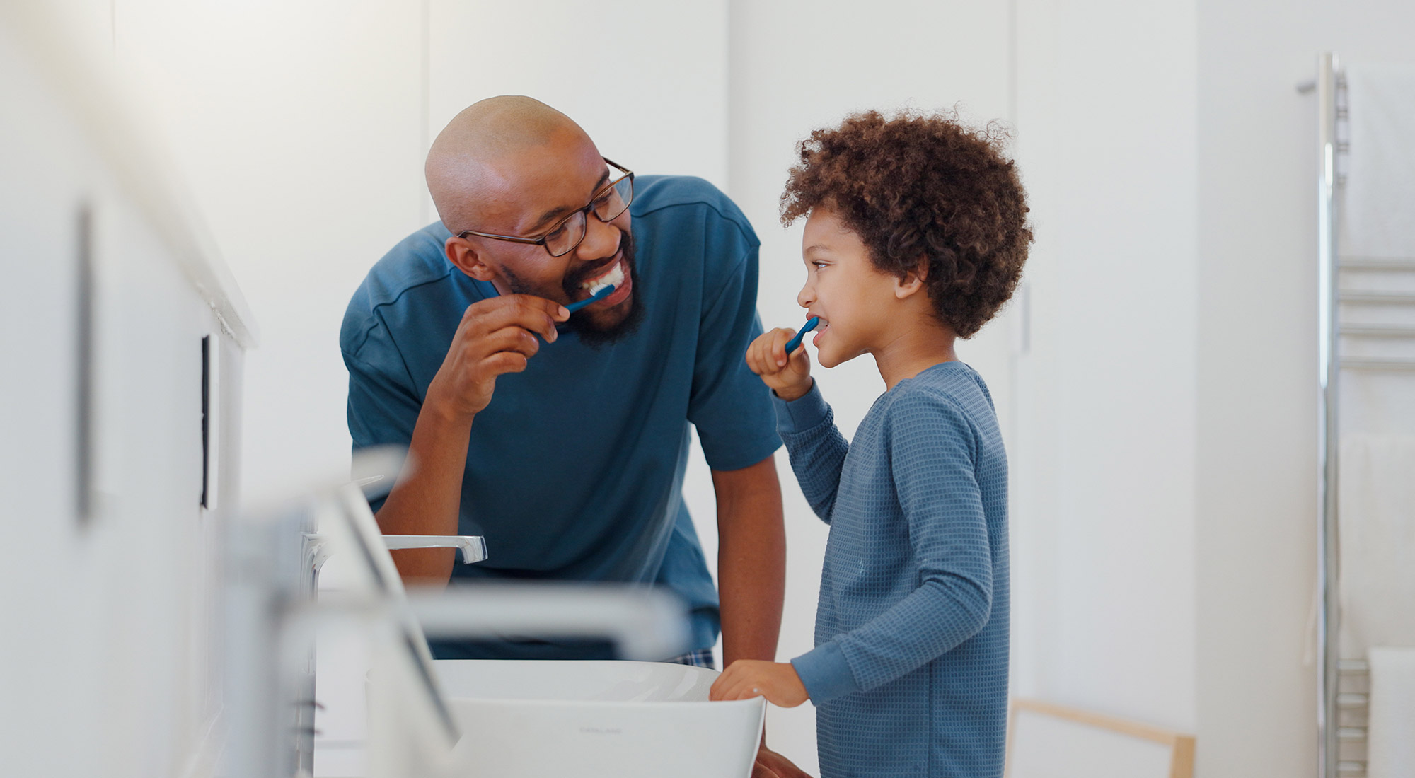 Autistic child following a morning routine with support from a parent