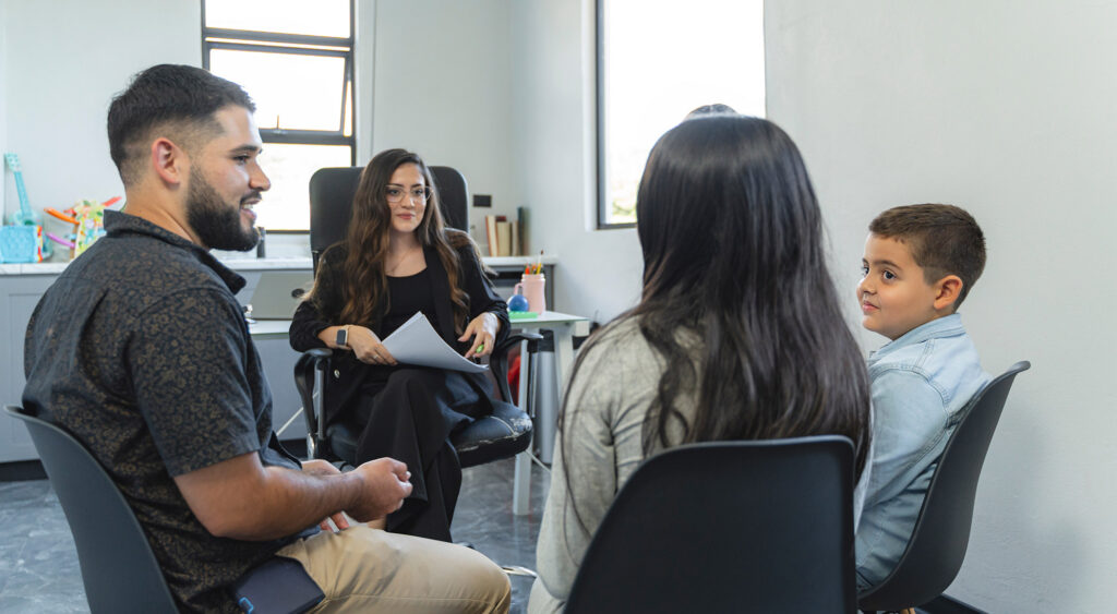 BCBA reviewing an ABA treatment plan with a parent