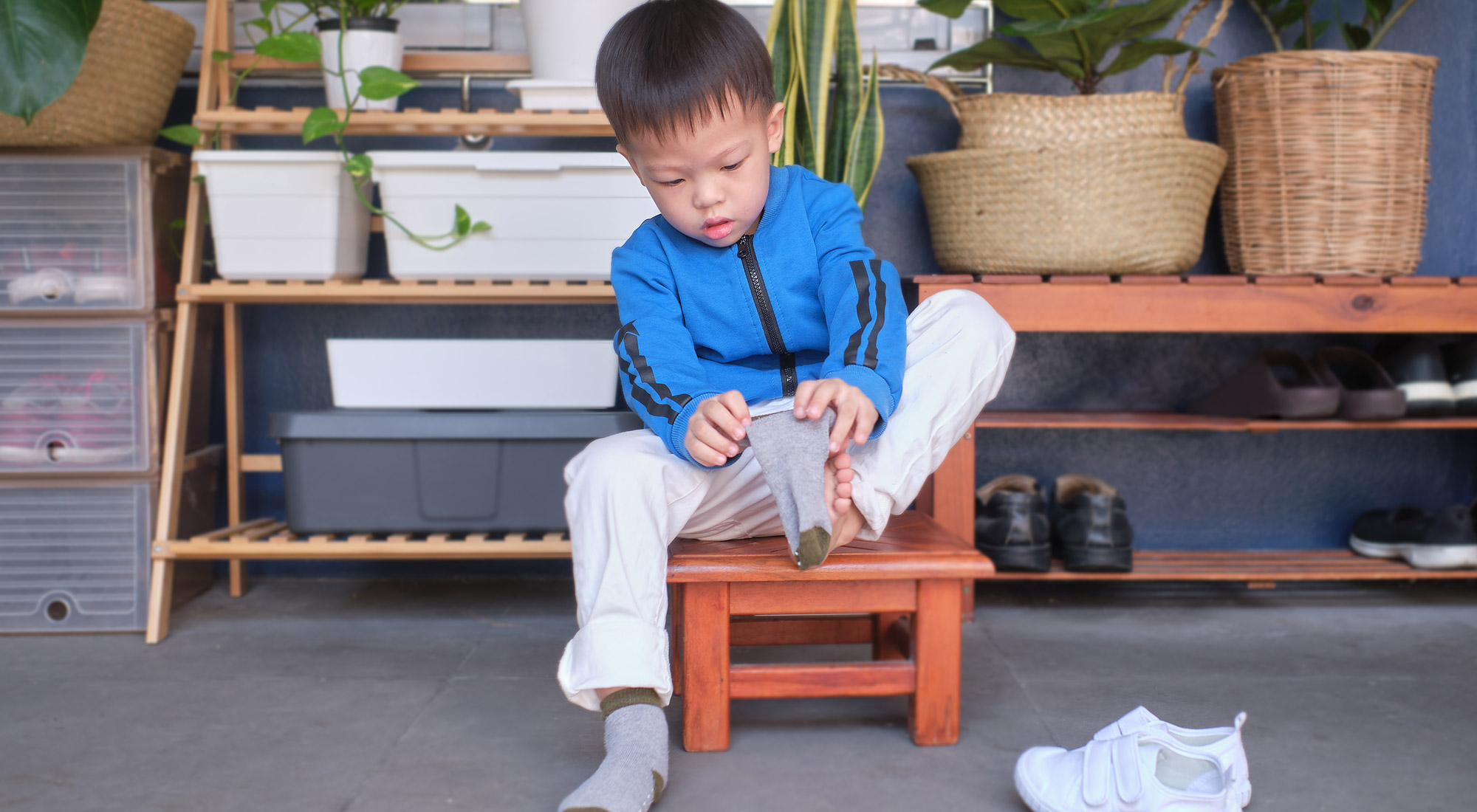 Child practicing independent dressing skills during a home routine