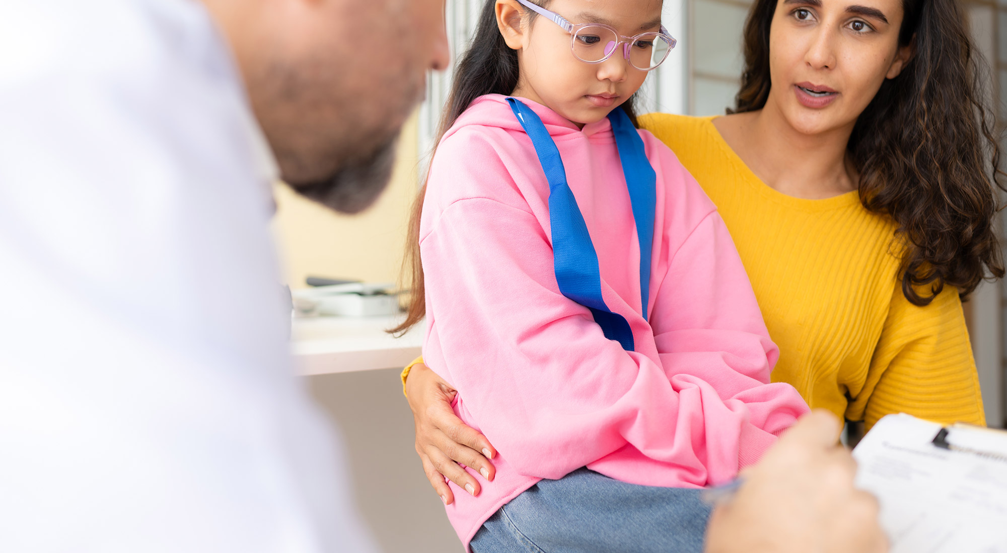 Parent discussing an ABA therapy treatment plan and progress with a BCBA