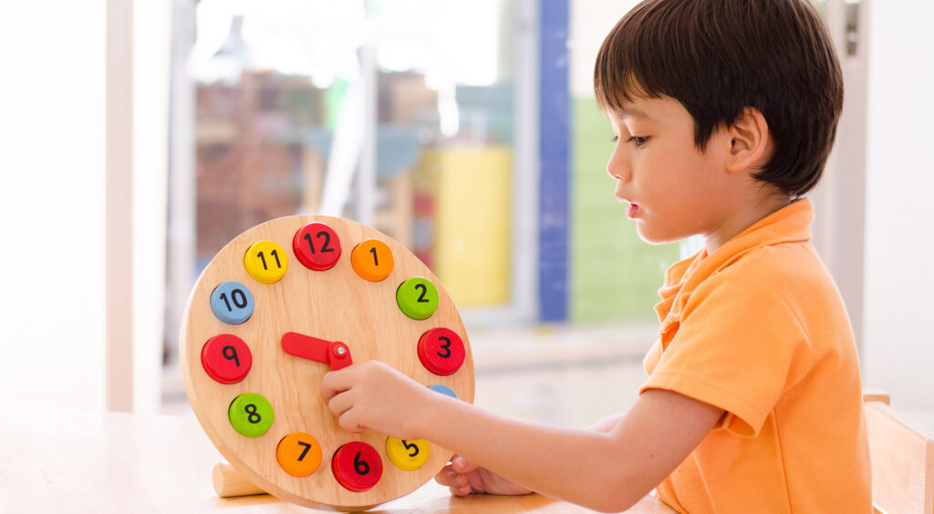 ABA therapy independence activity with child using a learning clock