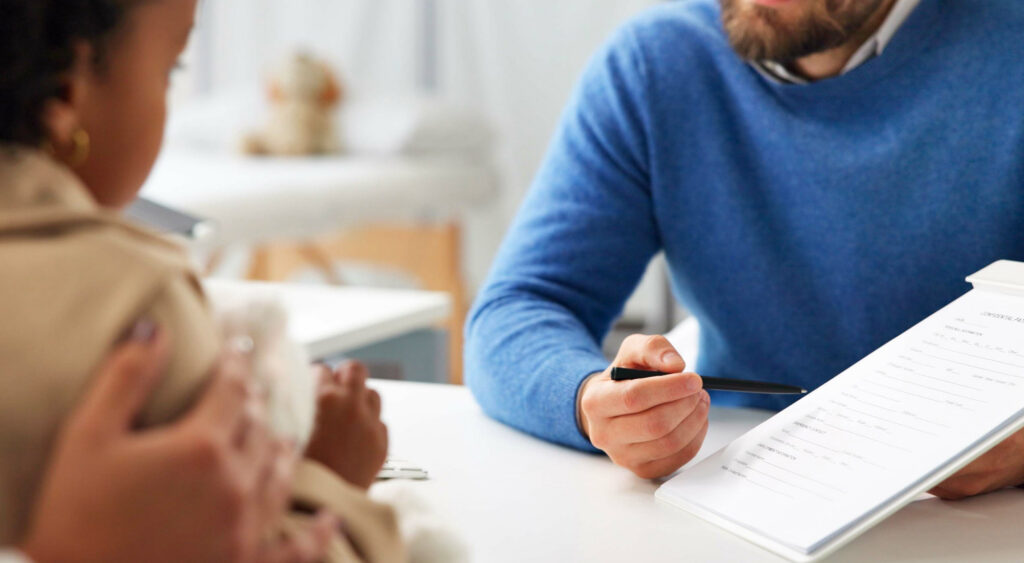 Parent reviewing insurance documents for a child’s ABA therapy